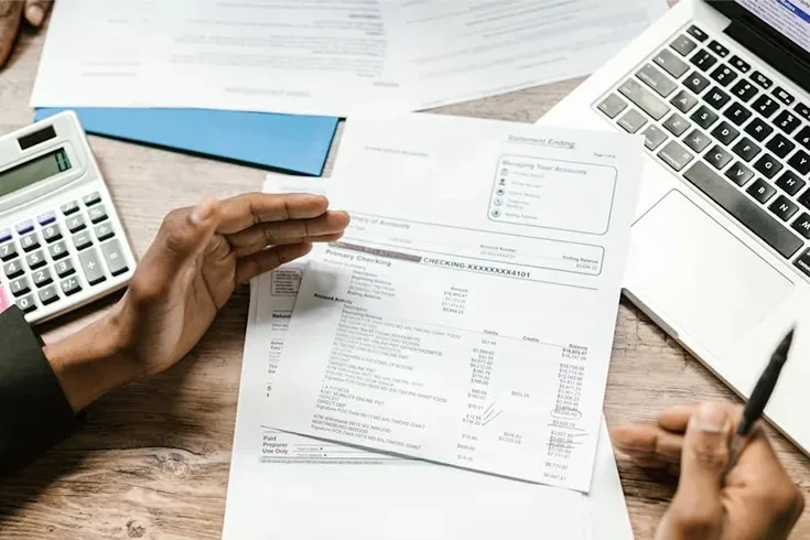 Business owner reviewing invoicing and compliance documents