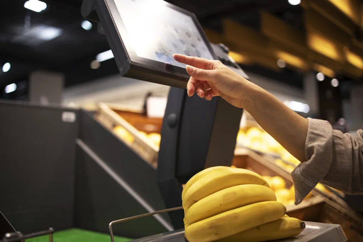 Retail worker using a physical POS terminal